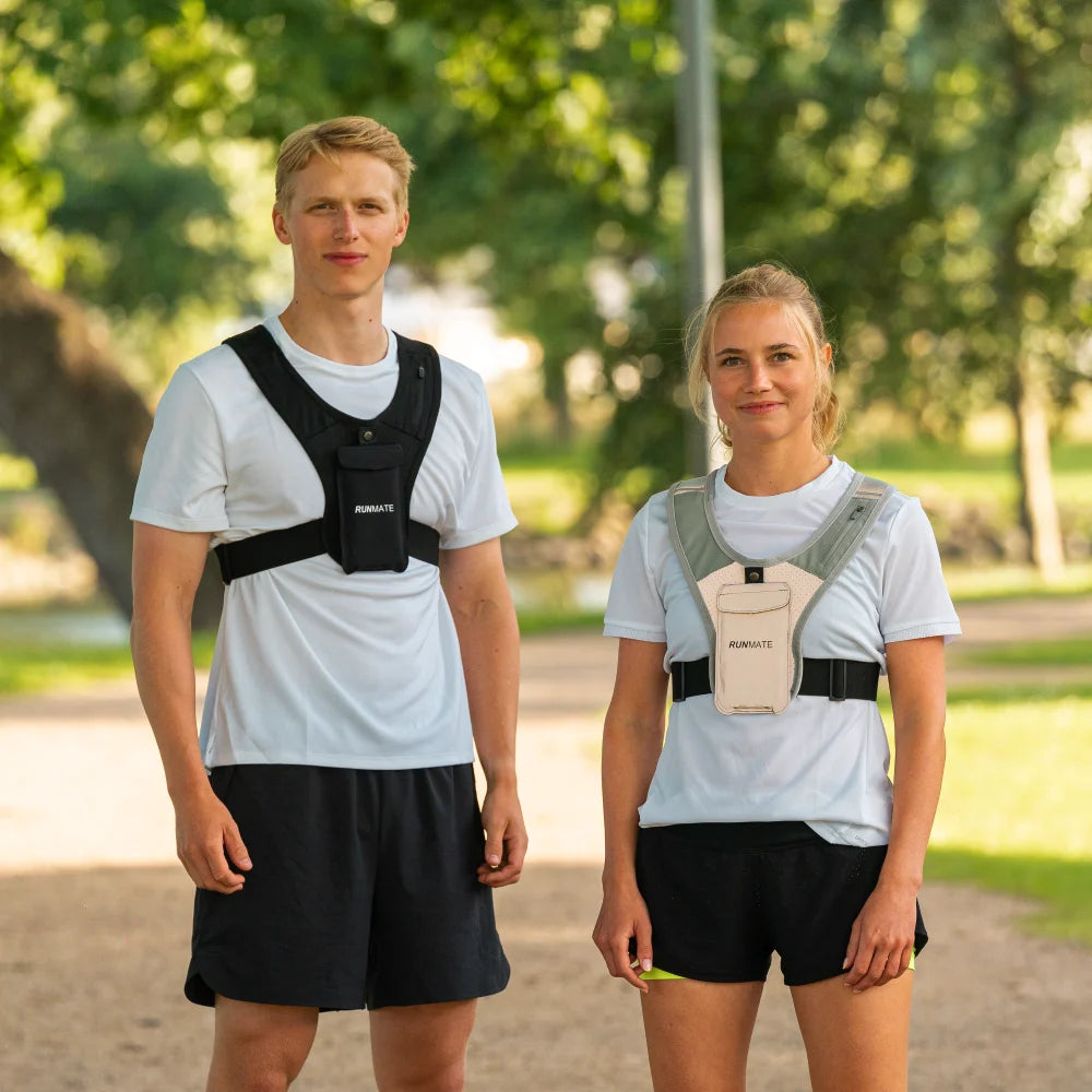 Dette er et billede af en kvinde og en mand i løbeveste fra RUNMATE set forfra i en park
